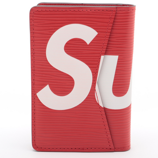 Red wallet with white 'Supreme' logo on a white background