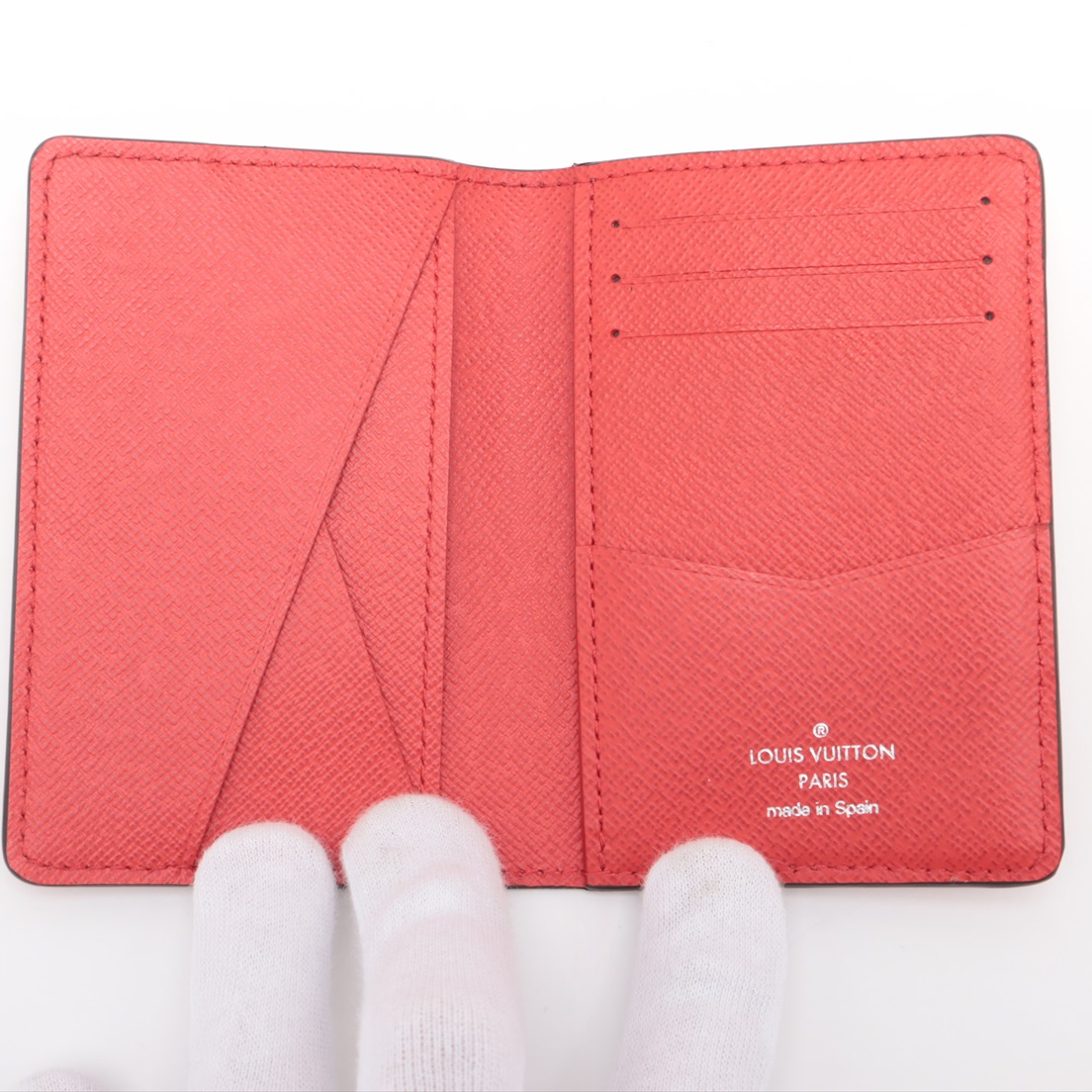 Red Louis Vuitton wallet with visible branding on a white background