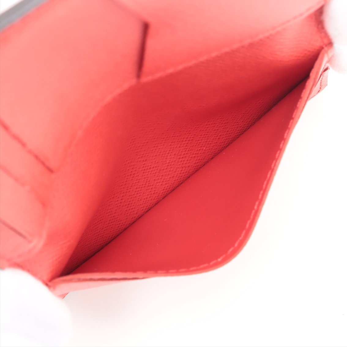 Close-up of a red seat cover with a white background