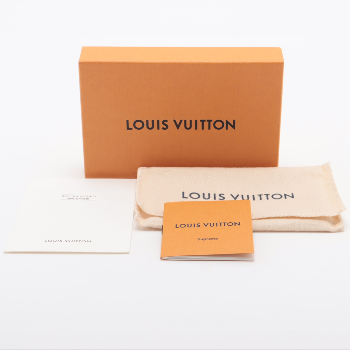 Louis Vuitton packaging including a box, pouch, and card on a white background