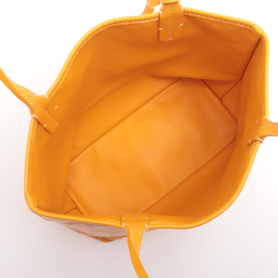 Yellow handbag with a visible brand logo on a white background