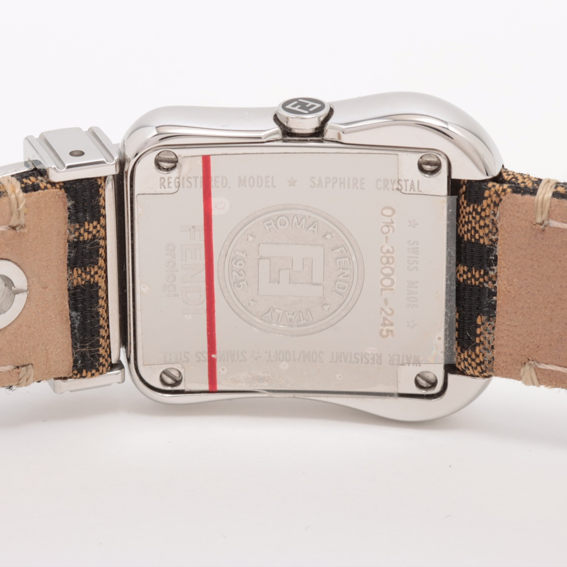 Close-up of a watch with a patterned strap on a white background