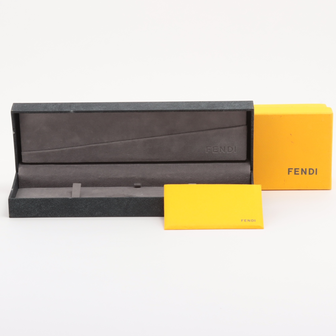 Fendi watch case with yellow accents on a white background