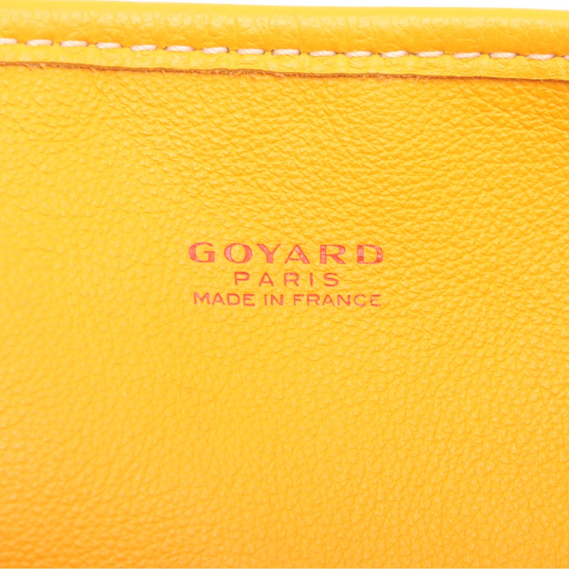 Close-up of a yellow Goyard bag with 'Made in France' text.