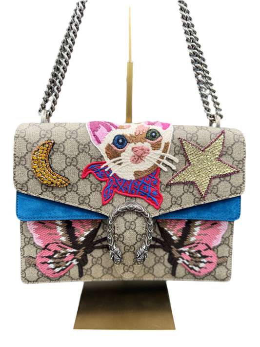 Gucci Dionysus handbag with a colorful suede interior and a multicolored design featuring a cat, moon, and star on the front.
